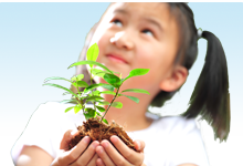 Young girl holdling a plant in her hands